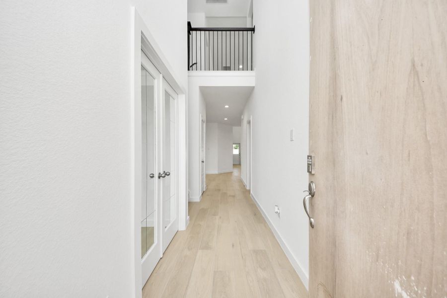 As you step into the threshold of this luxurious home, you'll soon be welcomed by an elegant glass door (to be installed). Inside, soaring ceilings amplify the spaciousness, while the refined wood-look tile flooring and oversized baseboards exude sophistication and charm. Sample photo of completed home with similar floor plan. Actual colors and selections may vary.