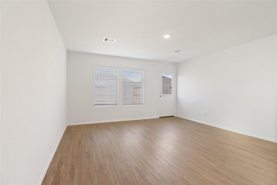 Light-filled living room with backyard access, clean modern finishes, and neutral tones Light-filled living room with backyard access, clean modern finishes, and neutral tones