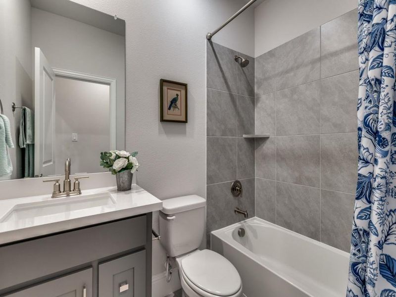 Full bathroom with shower / tub combo with curtain and vanity