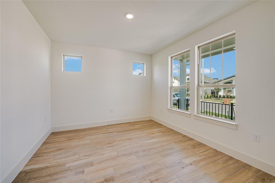 Spare room with light wood finished floors and recessed lighting