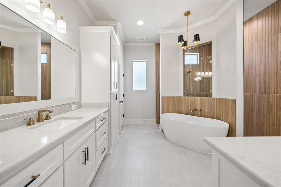 Full bathroom with vanity, ornamental molding, a freestanding bath, tile walls, and a shower