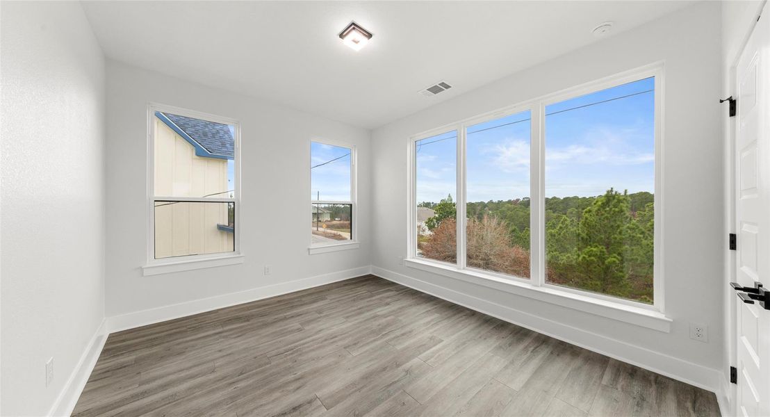 Spare room with baseboards and light wood-type flooring