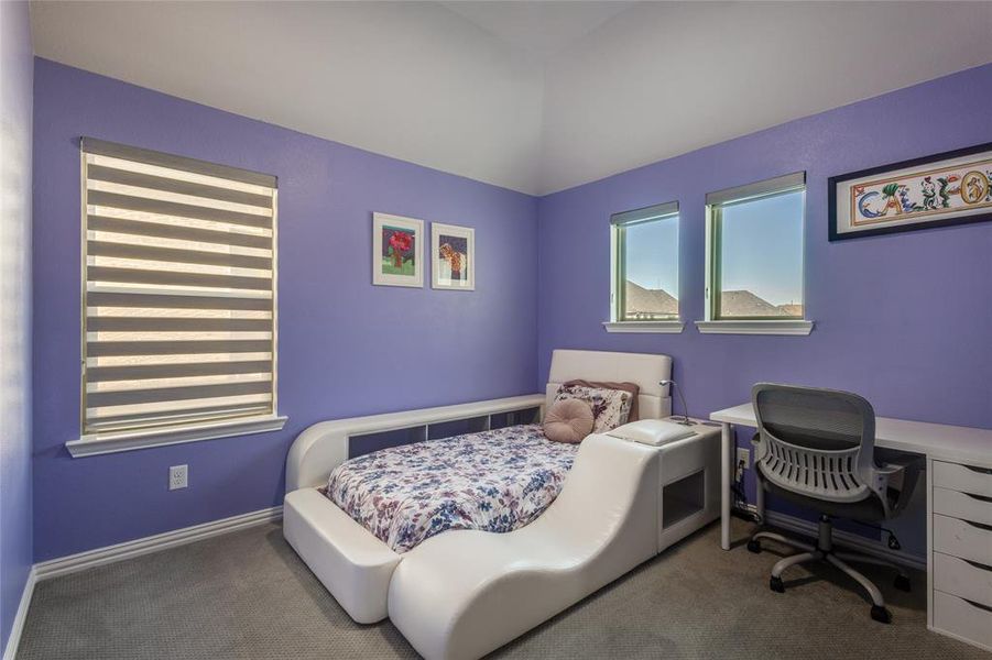 Carpeted bedroom featuring a desk