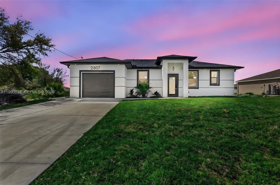 Front exterior of a new home in , Lehigh Acres, FL, highlighting curb appeal (Image 28).