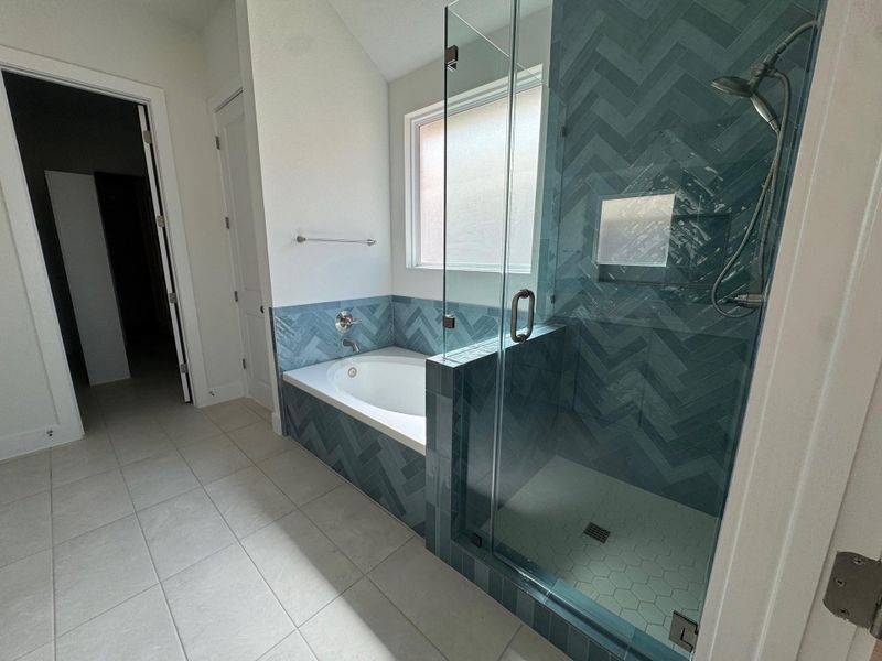 Full bath with a stall shower, a bath, and light tile patterned floors