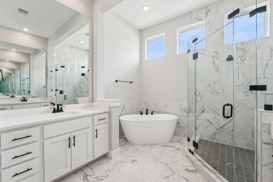 Bathroom with a marble finish shower, vanity, marble finish floor, a soaking tub, and visible vents Bathroom with a marble finish shower, vanity, marble finish floor, a soaking tub, and visible vents