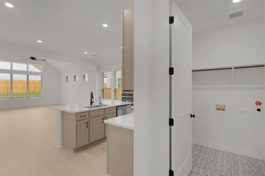 Washroom with recessed lighting, plenty of natural light, washer hookup, ceiling fan, and gas dryer hookup