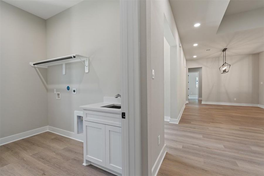 Laundry Suite! Check out that hanging rod and MUD Sink with a cabinet!