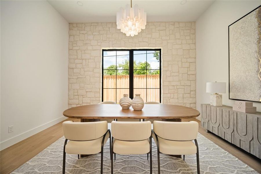 Dining space featuring wood finished floors and a chandelier