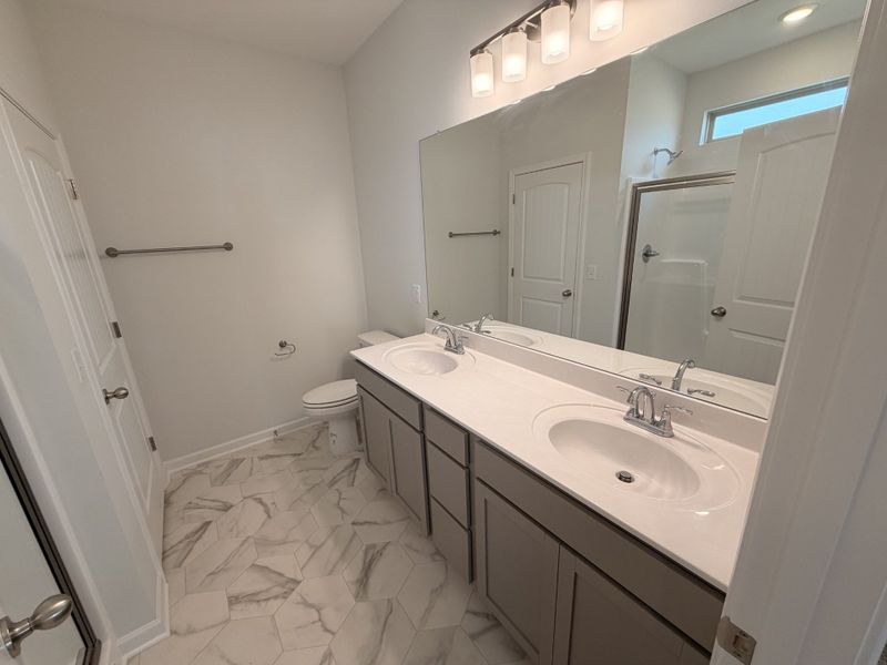 Primary Bathroom features: Separate Linen Closet, Double Sinks, Raised Vanity, easy clean Vinyl Flooring and Fiberglass Shower!