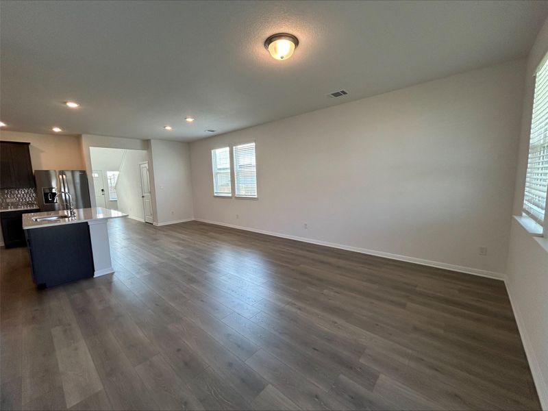 Unfurnished living room with dark wood-style floors and recessed lighting Unfurnished living room with dark wood-style floors and recessed lighting