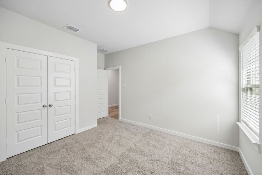 Bedroom in the Oscar home plan by Trophy Signature Homes – REPRESENTATIVE PHOTO