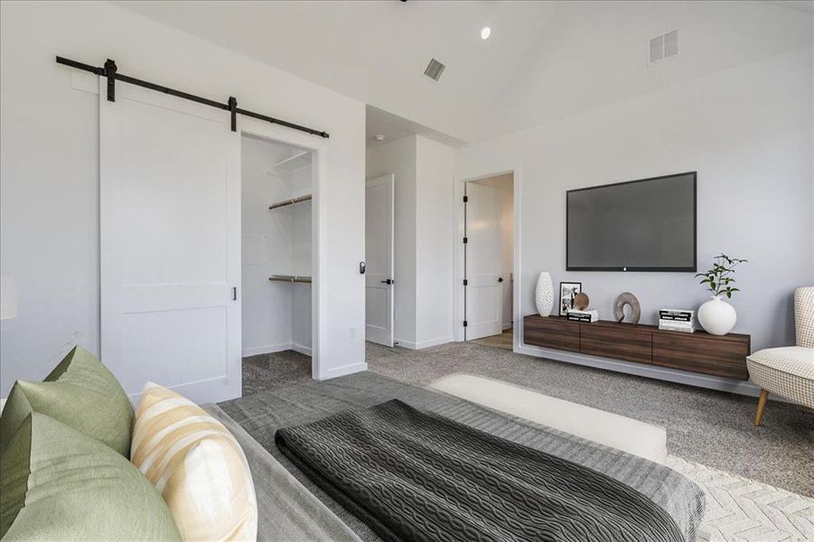 This spacious bedroom features vaulted ceilings and a practical barn door leading to the closet. This spacious bedroom features vaulted ceilings and a practical barn door leading to the closet.