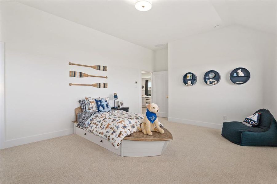 Carpeted bedroom with baseboards and vaulted ceiling Carpeted bedroom with baseboards and vaulted ceiling