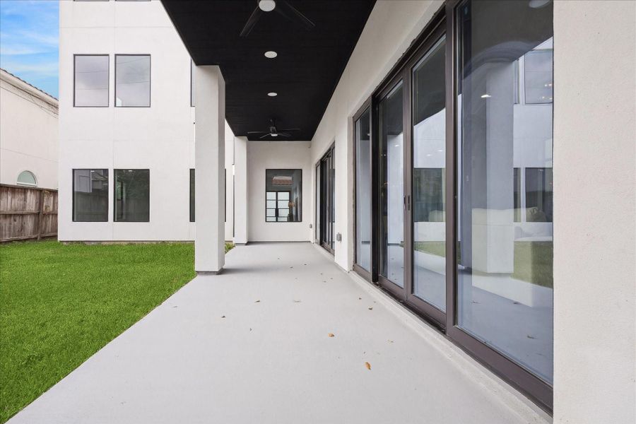 Outside of the large sliding glass doors, the backyard is a pool-ready,  private oasis featuring a spacious patio and pre-installed hookups for an outdoor kitchen, providing the perfect setting for entertaining or relaxing outdoors.