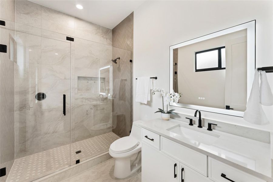 Secondary bathroom with walk-in shower.