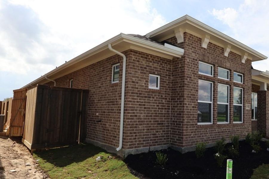 Front exterior of a new home in Riceland 50’ Alley Load Homesites, Mont Belvieu, TX, highlighting curb appeal (Image 17).