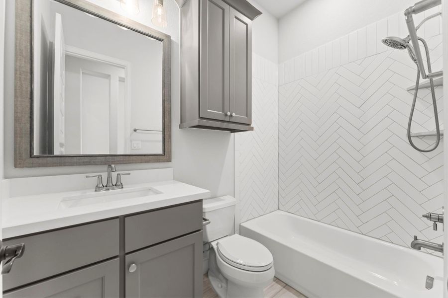 This secondary bath features beautiful tilework and plenty of storage. This secondary bath features beautiful tilework and plenty of storage.