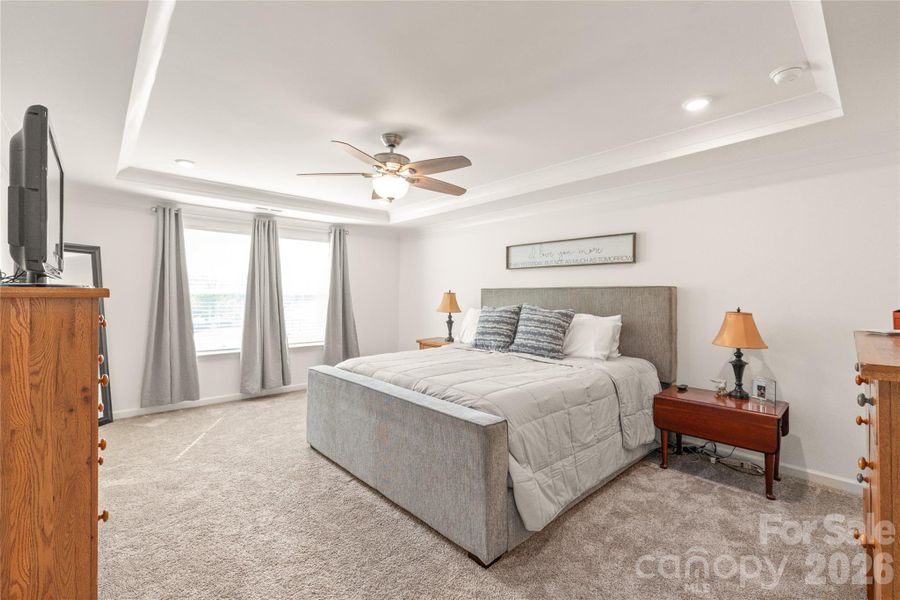 Spacious primary with trayed ceilings gives you many options