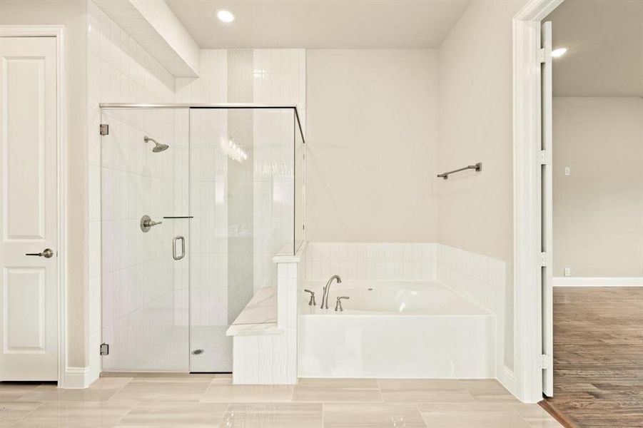 Bathroom with a bath, a shower stall, and recessed lighting