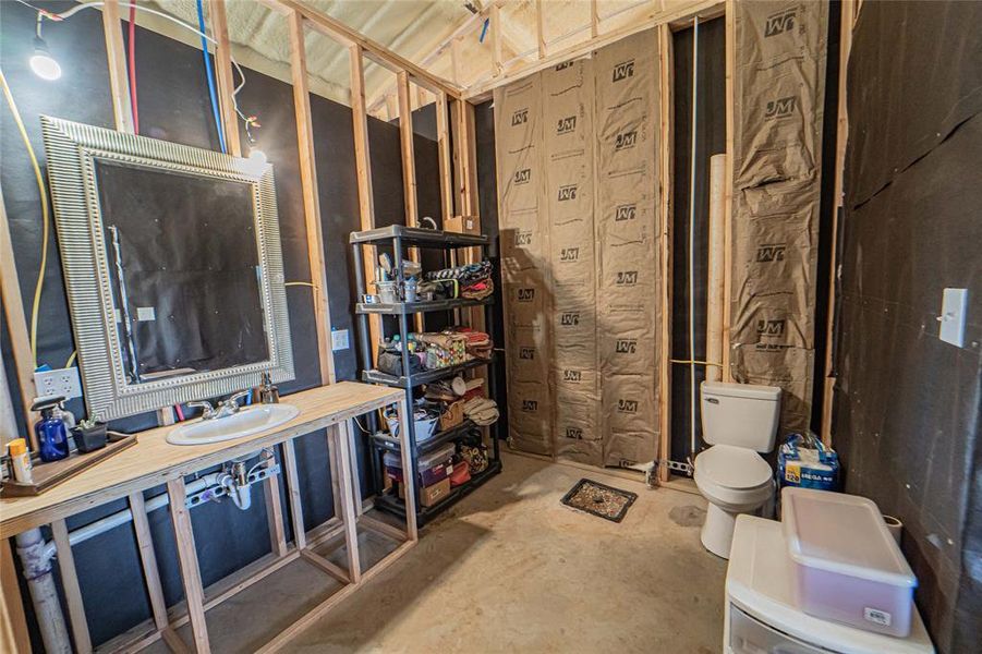 Bathroom featuring unfinished concrete floors and vanity