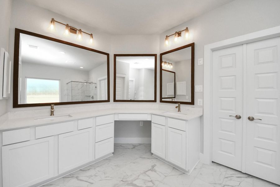 Elevate your daily routine at the elegant vanity, now equipped with double sinks, light countertops, modern hardware, and beautiful vanity lights. Elevate your daily routine at the elegant vanity, now equipped with double sinks, light countertops, modern hardware, and beautiful vanity lights.