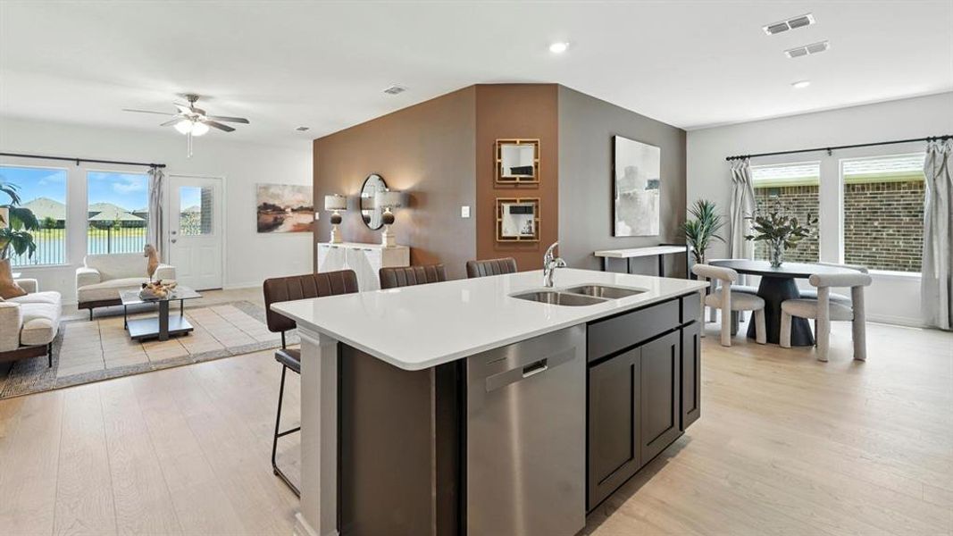 Kitchen featuring plenty of natural light, a kitchen bar, open floor plan, and recessed lighting