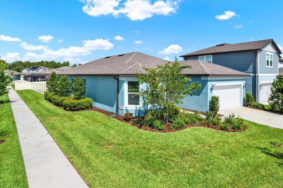 Front exterior of a new home in , Land O' Lakes, FL, highlighting curb appeal (Image 24).