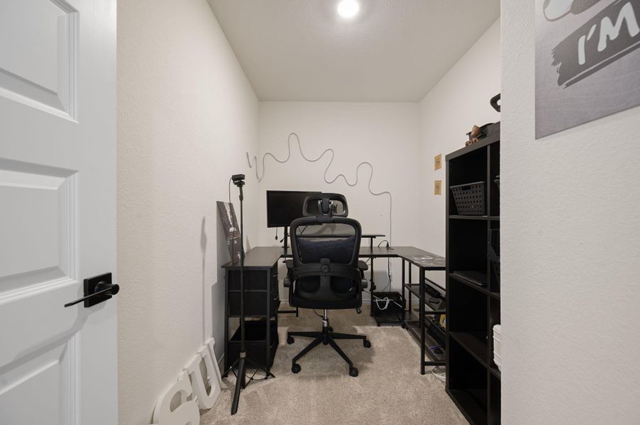 Office space featuring light carpet