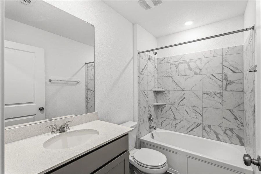 Bathroom with vanity and washtub / shower combination