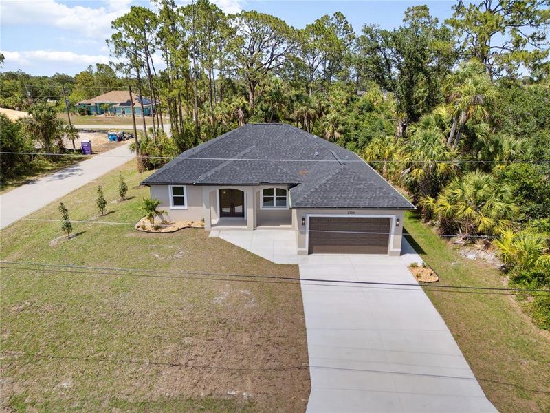 Front exterior of a new home in , North Port, FL, highlighting curb appeal (Image 1).