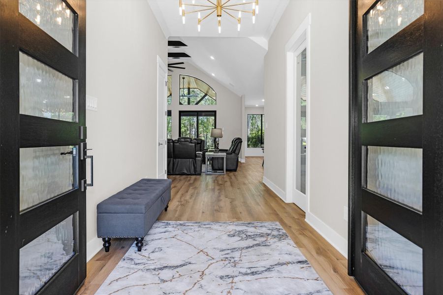 Grand entry with high ceilings and natural light