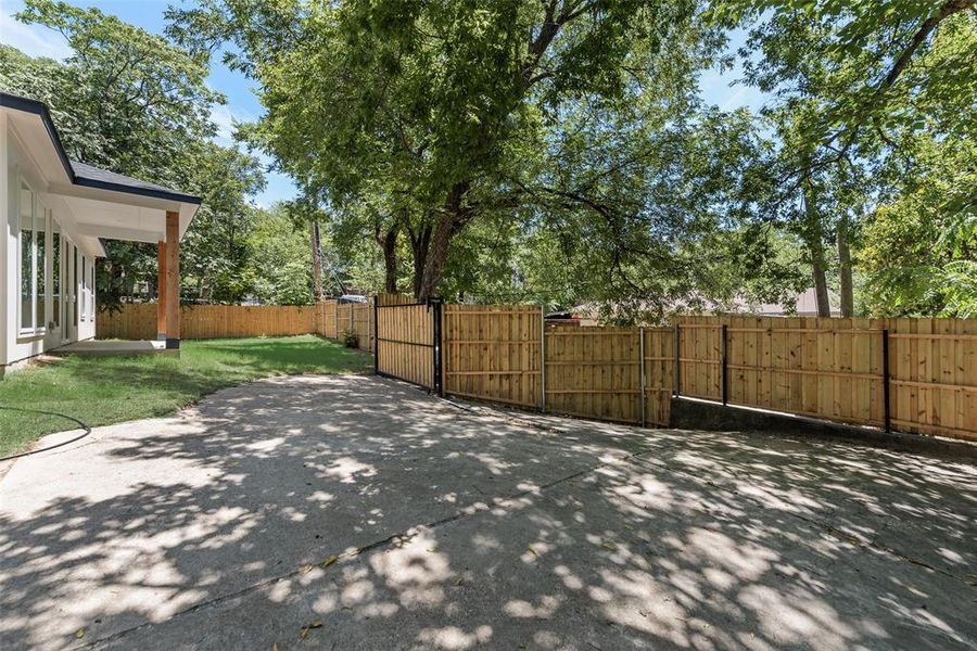 Fenced backyard with a patio and a gate