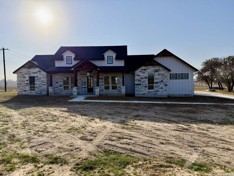 Front exterior of a new home in , Floresville, TX, highlighting curb appeal (Image 23).