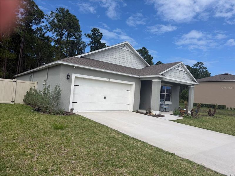 Front exterior of a new home in Fountain View, Ormond Beach, FL, highlighting curb appeal (Image 2). Front exterior of a new home in Fountain View, Ormond Beach, FL, highlighting curb appeal (Image 2).