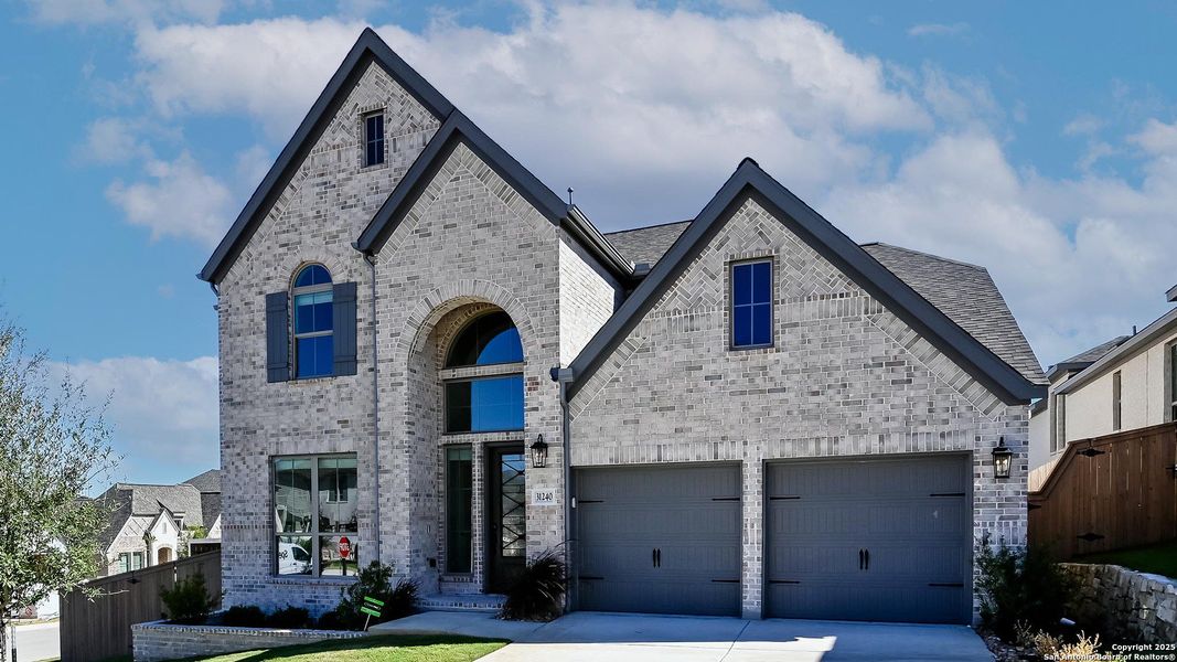 Front exterior of a new home in Johnson Ranch 55', Bulverde, TX, highlighting curb appeal (Image 18). Front exterior of a new home in Johnson Ranch 55', Bulverde, TX, highlighting curb appeal (Image 18).