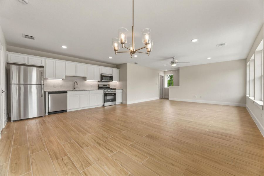 View from the dining room looking at the kitchen and living. All stainless steel appliances and great cabinet space.