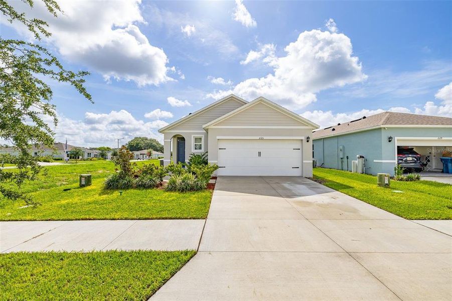 Front exterior of a new home in Bradbury Creek, Haines City, FL, highlighting curb appeal (Image 22). Front exterior of a new home in Bradbury Creek, Haines City, FL, highlighting curb appeal (Image 22).