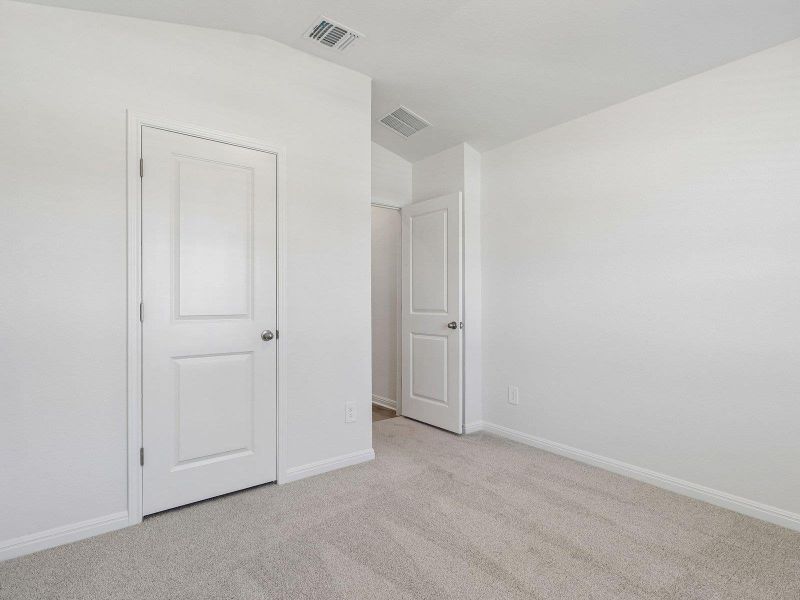 Soft carpeting underfoot defines this minimalist space ready for personal customization.