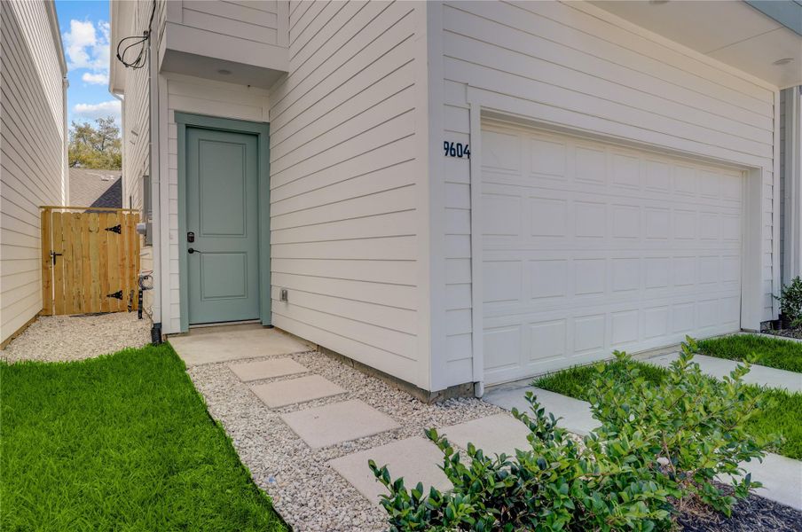 The home has a covered front entry and solid front door.