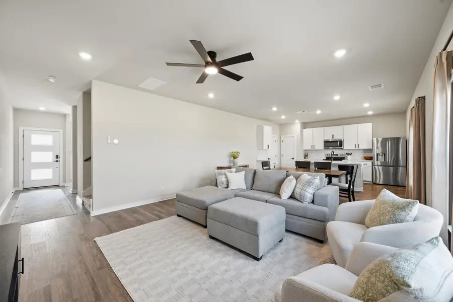 Recessed lighting and warm wood-style flooring flow through this airy, open-concept living space. Recessed lighting and warm wood-style flooring flow through this airy, open-concept living space.