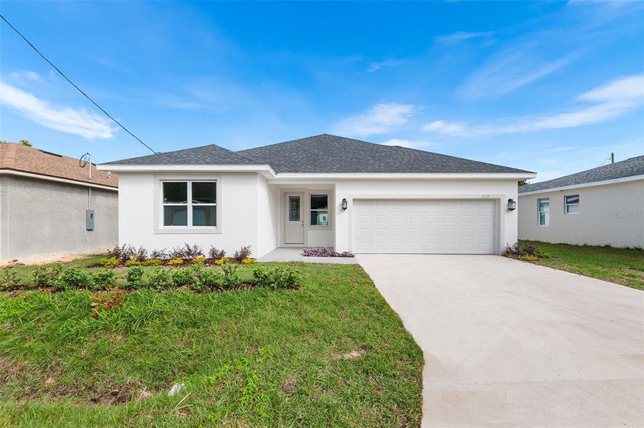 Front exterior of a new home in , Winter Haven, FL, highlighting curb appeal (Image 1). Front exterior of a new home in , Winter Haven, FL, highlighting curb appeal (Image 1).