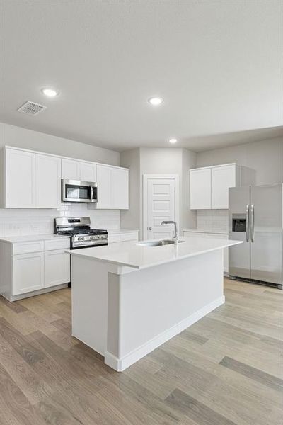 Kitchen in the Holden home plan by Trophy Signature Homes – REPRESENTATIVE PHOTO