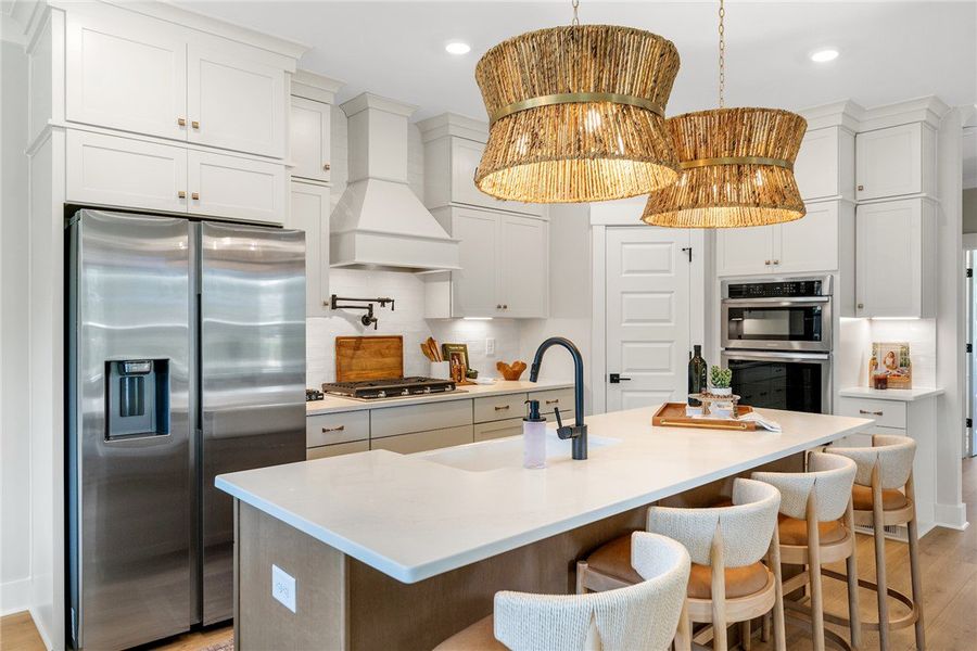 This modern kitchen features a spacious island, sl
