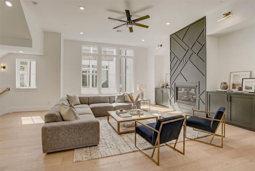 Incredible second floor living room with gas-log fireplace and stunning natural light. Virtually staged photo. Incredible second floor living room with gas-log fireplace and stunning natural light. Virtually staged photo.