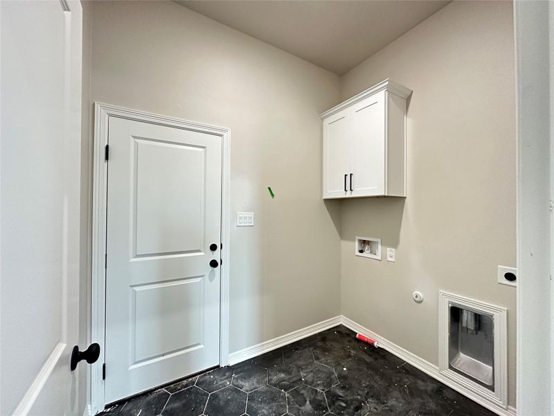 Laundry area with gas dryer hookup, hookup for a washing machine, cabinet space, and hookup for an electric dryer