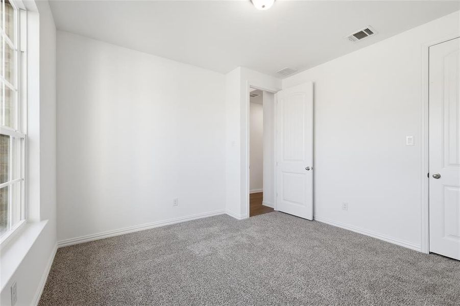 Unfurnished bedroom with carpet and baseboards