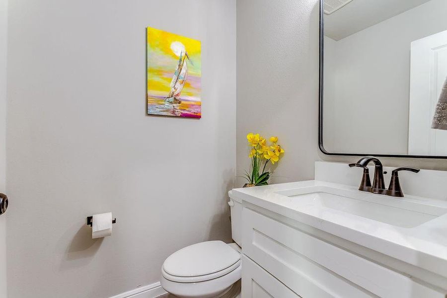 Bathroom featuring vanity and toilet