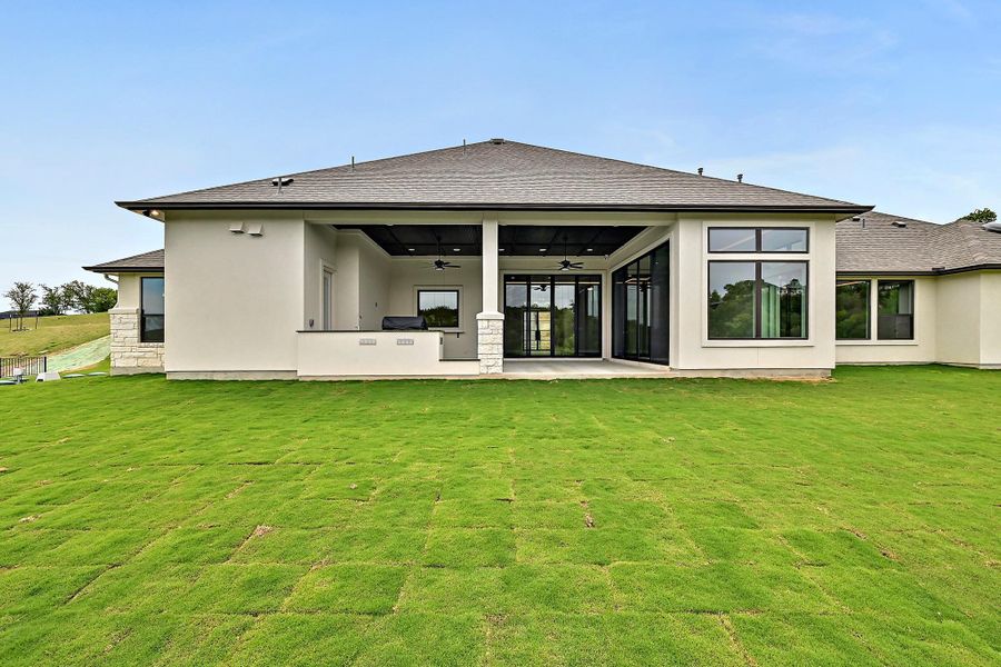 A spacious backyard with newly laid sod and an inviting covered patio, perfect for outdoor entertainment. A spacious backyard with newly laid sod and an inviting covered patio, perfect for outdoor entertainment.