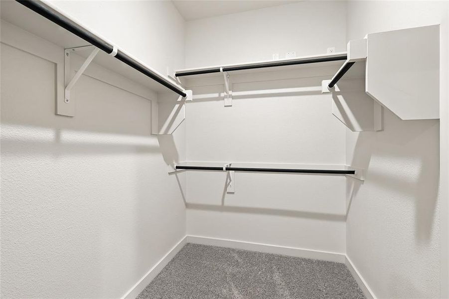 Spacious closet with light colored carpet Spacious closet with light colored carpet